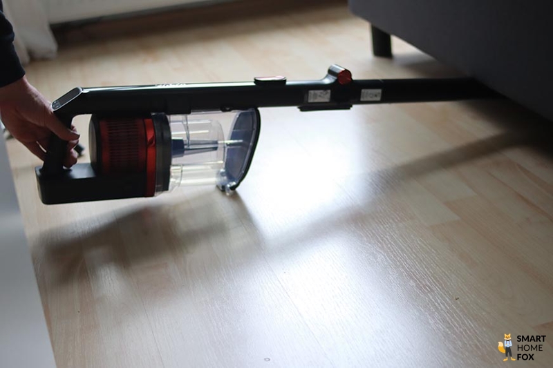 Shark Anti Hair Wrap Flexoloxy is seen cleaning under furniture.